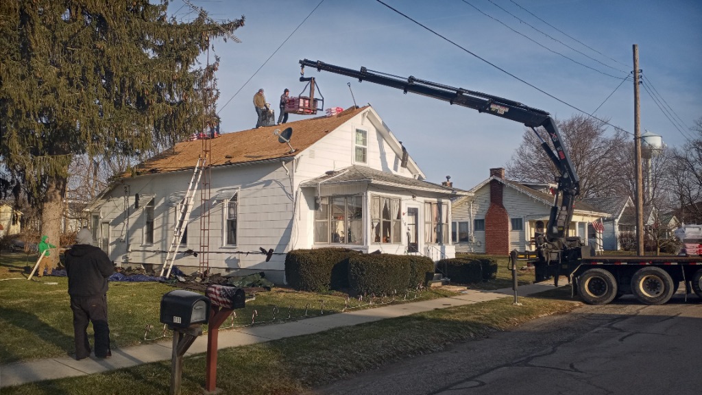 Roofing work in progress with crane