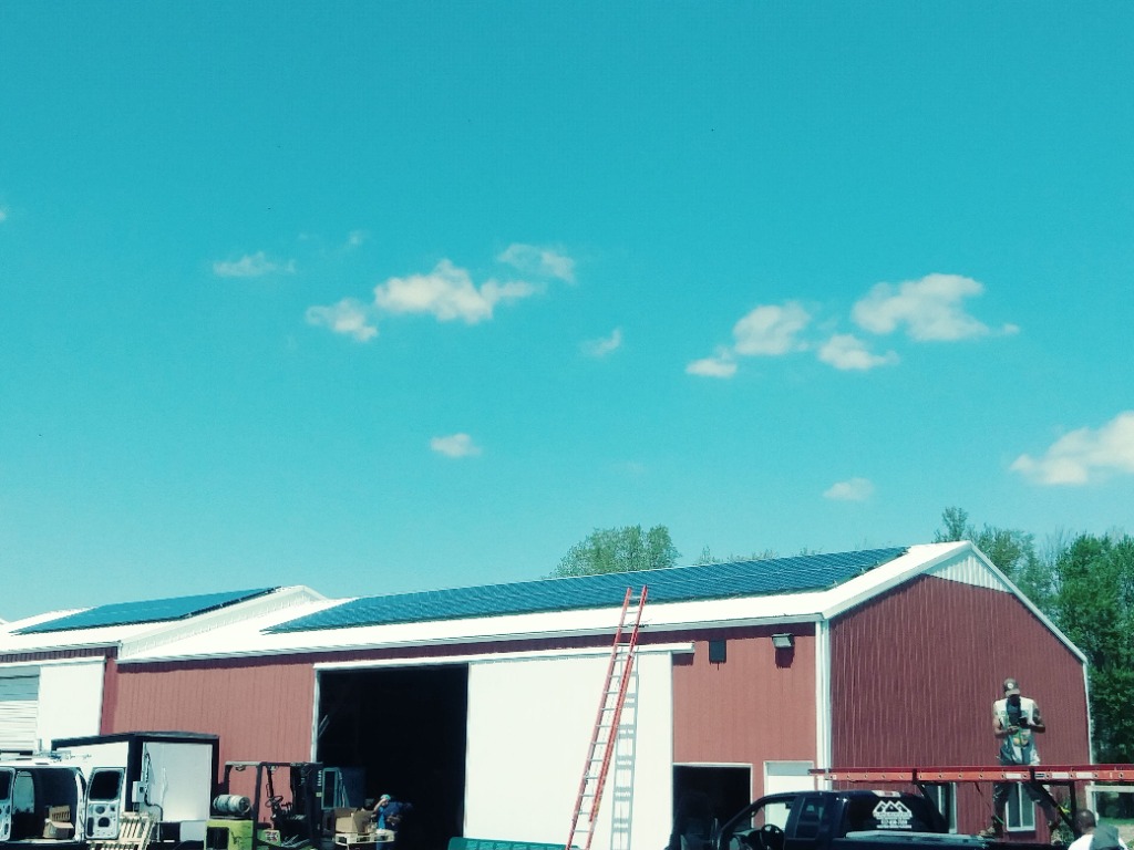 Technicians installing roof-mounted solar